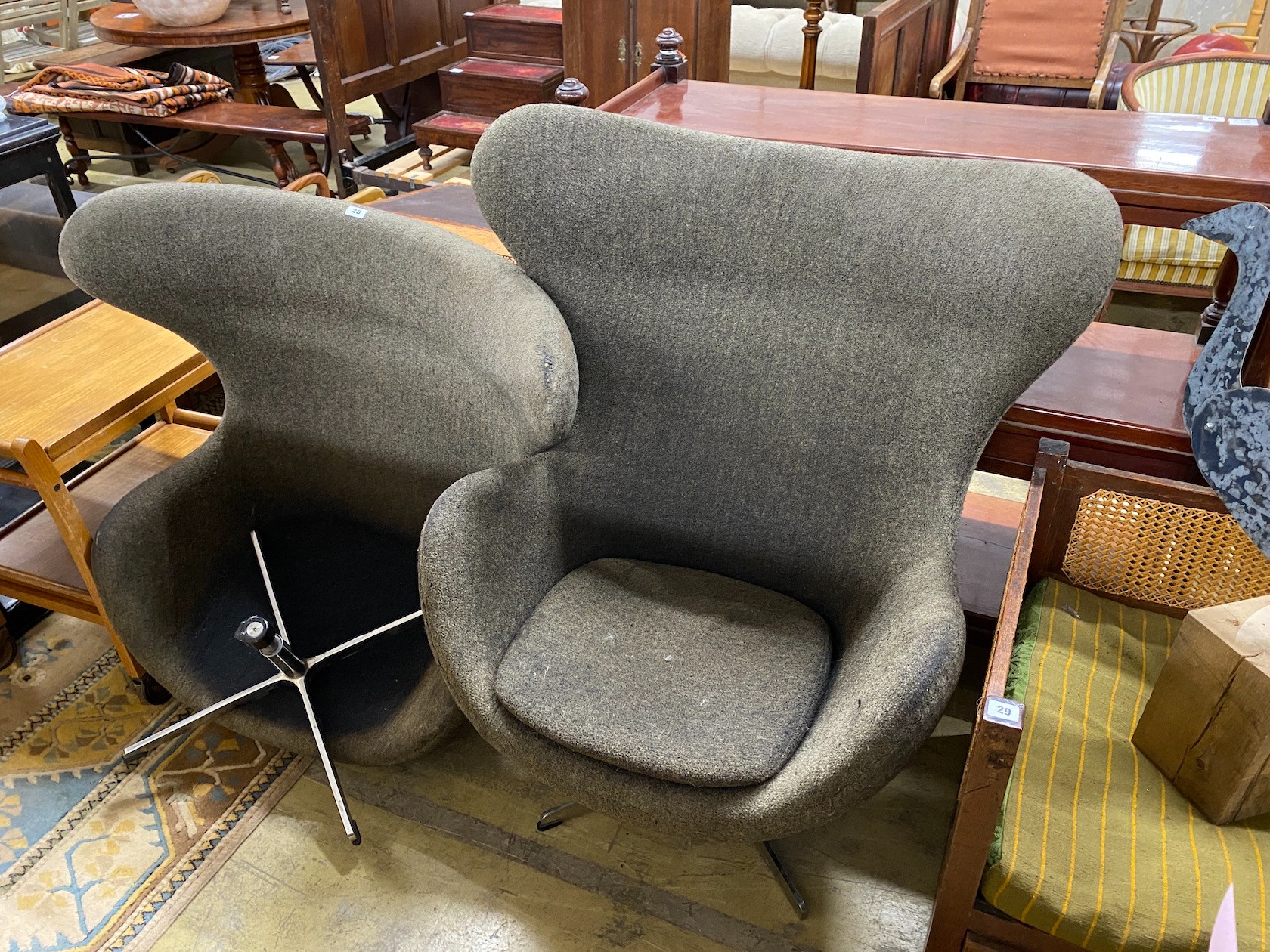 A pair of Arne Jacobsen style egg chairs, one needing restoration, width 85cm, depth 62cm, height 114cm